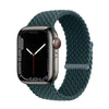 A dark green braided stretch band worn around an Apple Watch.