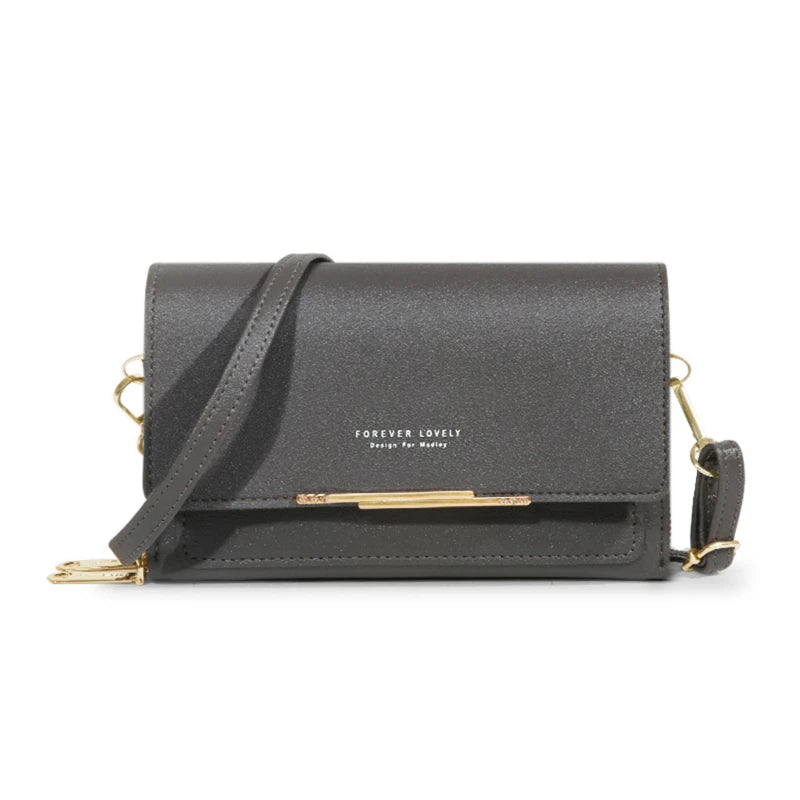 A dark gray women's multi-card shoulder wallet with gold hardware and a leather strap.