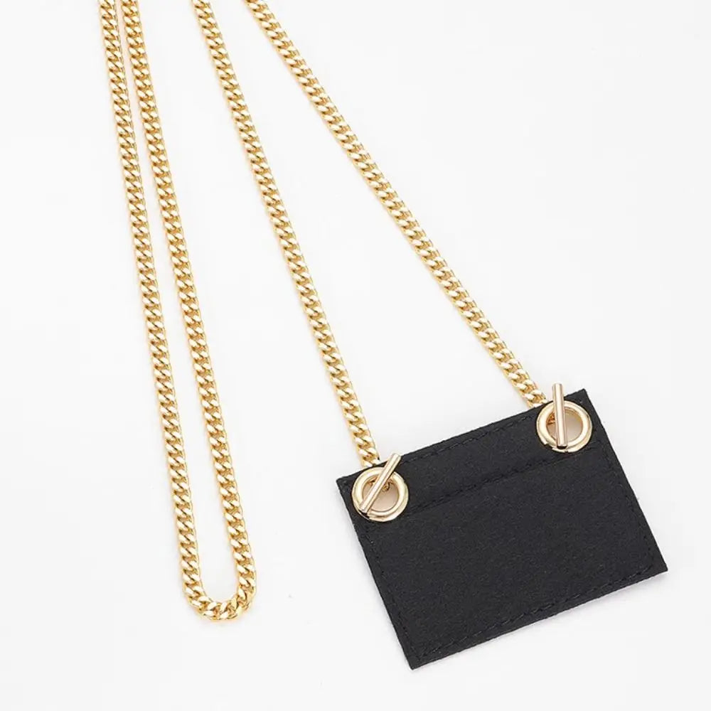 A gold chain strap attached to a black fabric tag, suitable for handbags and crossbody bags.