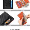 An orange and black RFID-blocking bi-fold wallet showing card slots, coin pockets, and banknote storage.