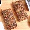 A patterned bohemian wood-grain leather wallet with multiple card slots resting on a light wooden surface.