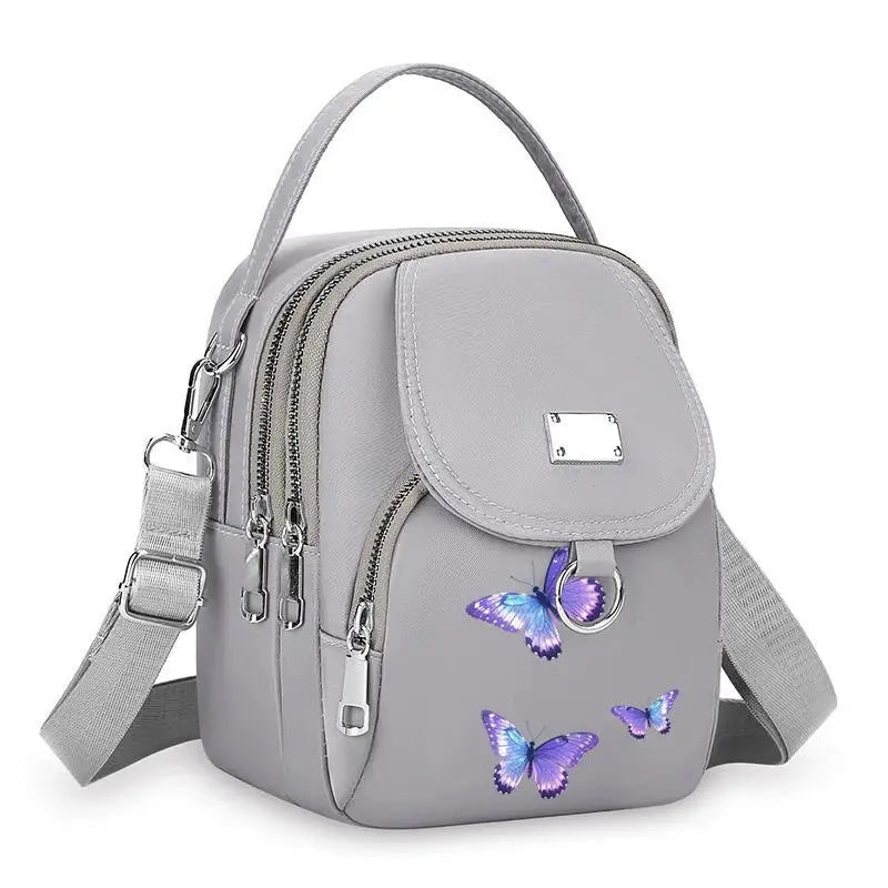 Sac bandoulière robuste gris à motif floral avec fermeture éclair et sangle réglable.