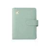 A light mint green RFID-blocking travel passport organizer with a leather cover and card slots.