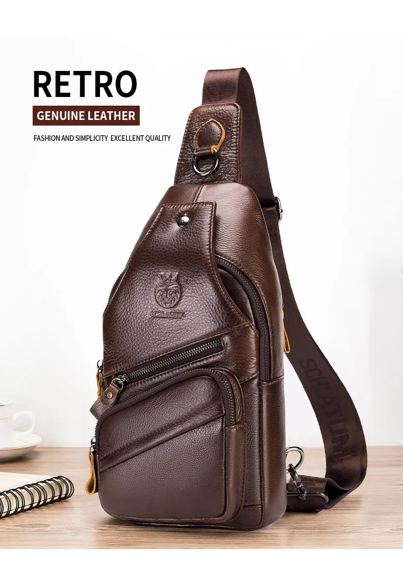 A dark brown genuine leather men's crossbody messenger bag with a gold-toned strap is shown on a wooden surface.