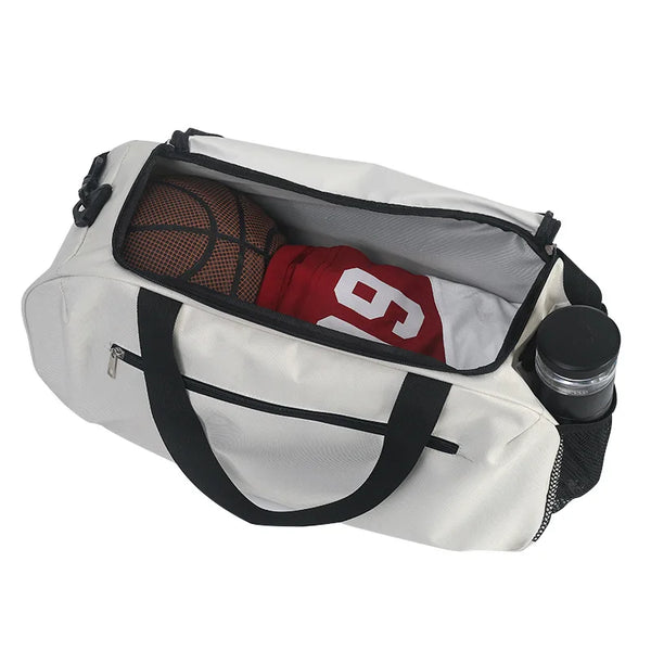 A white waterproof sports duffel bag containing a basketball and a red shirt.