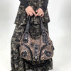 A leopard print crossbody shoulder bag with multiple compartments worn by a person in camouflage clothing.