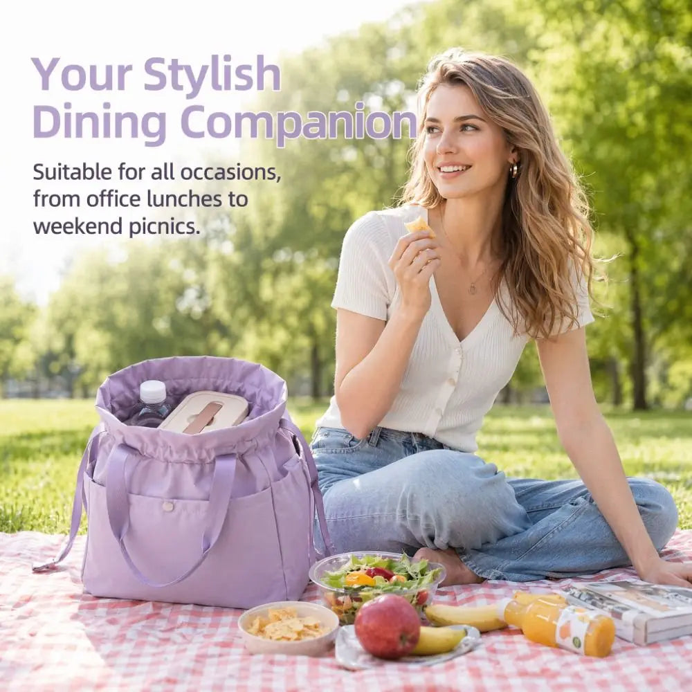 A woman is sitting outdoors with a purple insulated drawstring lunch bag and various picnic foods on a checkered blanket.