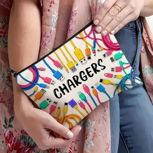 A hand holds a canvas zipper storage pouch filled with various electronic chargers and cables.