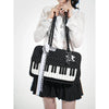 A woman holds a black and white piano print crossbody bag with musical note embroidery.