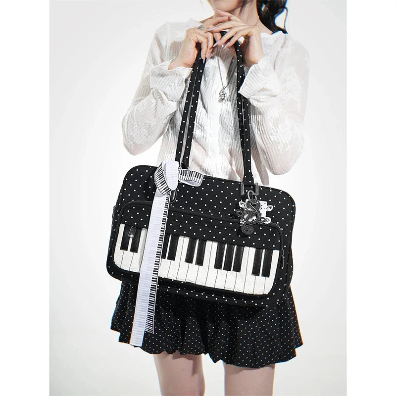 A woman holds a black and white piano print crossbody bag with musical note embroidery.