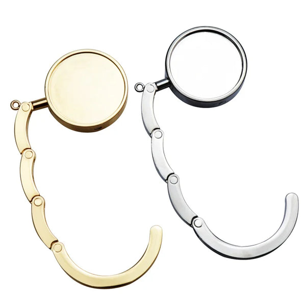 A pair of folding alloy handbag hangers with circular hooks and curved arms.