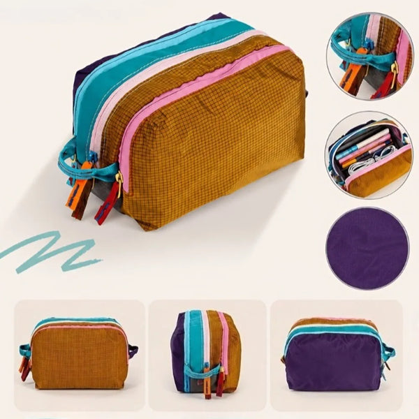 A brown multi-compartment travel toiletry organizer bag with pink and teal accents, shown alongside various accessories.