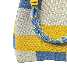 A geometric colorblock knitted bucket bag featuring yellow, blue, and white stripes with a blue drawstring.