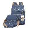 A navy blue canvas student backpack patterned with white stars and featuring tan straps.