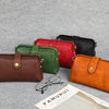 A collection of five genuine leather crossbody bags in shades of brown, green, red, black, and orange displayed on a gray bac