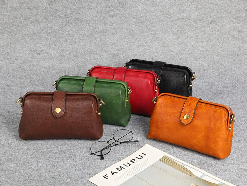 A collection of five genuine leather crossbody bags in shades of brown, green, red, black, and orange displayed on a gray bac