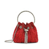 A red crystal-embellished evening clutch featuring a gold chain strap.
