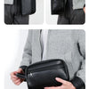 A black elegant PU leather clutch bag is shown being held by a person wearing a gray blazer and dark trousers.