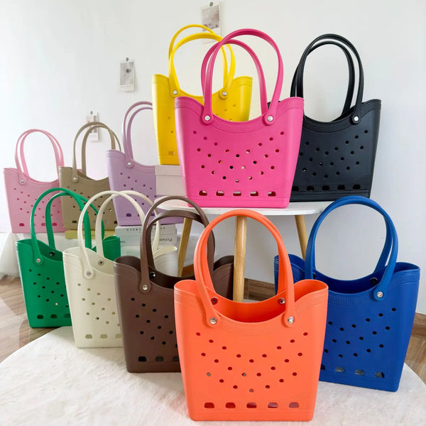 Colección de bolsas tote impermeables de EVA coloridas en varios tonos, incluyendo rosa, amarillo, púrpura, verde y negro, ex
