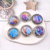 A set of five round metal hooks featuring colorful marble and starry sky designs on a white background.