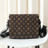 A brown men's casual crossbody bag with an easy flap design resting on a white table.