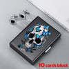 A black slim card holder featuring a skull design with blue butterfly accents, next to silver clip earrings.
