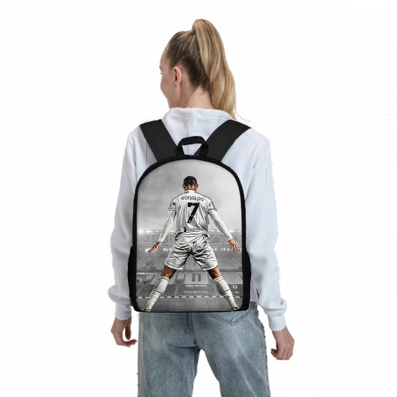 A white long-sleeve shirt with a black backpack featuring a cartoon image of a football player in a Juventus kit.
