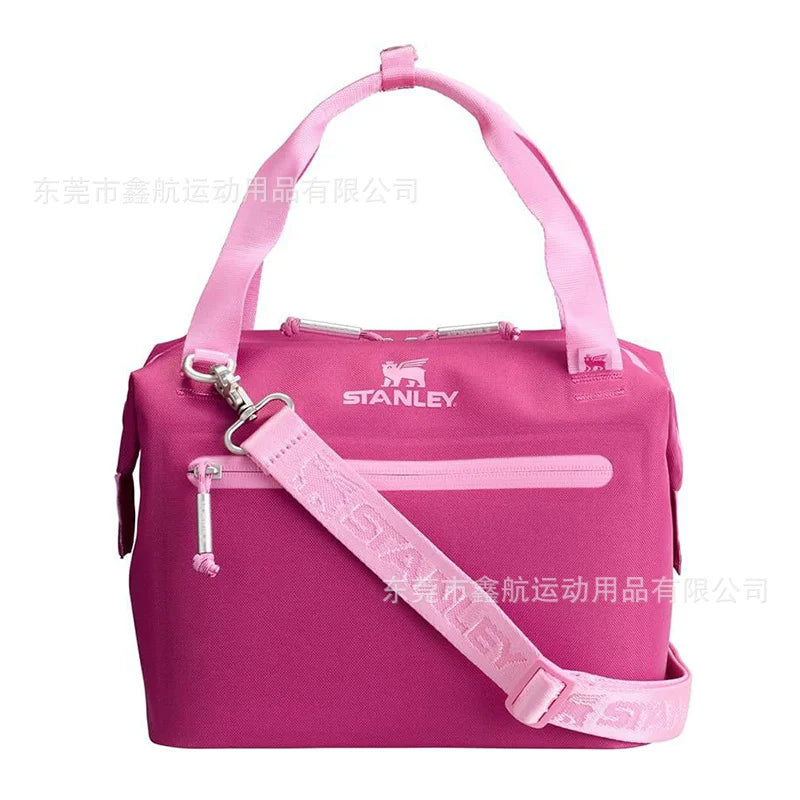 A pink insulated cooler lunch bag with a detachable crossbody strap.