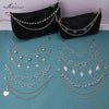 Black shoulder bag decorated with multiple layers of silver metal chain straps and charms
