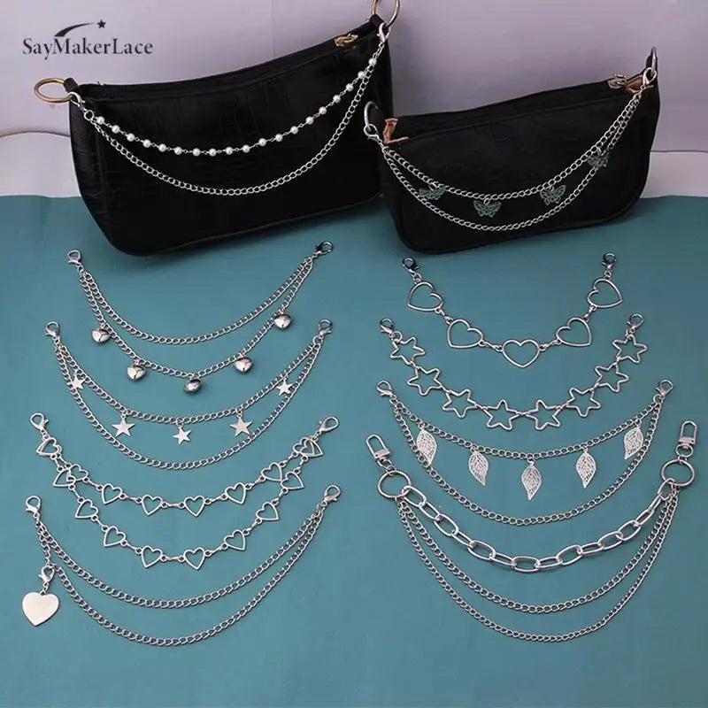 Black shoulder bag decorated with multiple layers of silver metal chain straps and charms