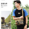 A young man wearing a black t-shirt and light pants holds a camouflage tactical fanny pack outdoors.