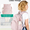 A woman is wearing a pink quilted backpack designed for the little things, featuring large side pockets and a water bottle ho