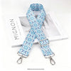 A light blue and white patterned nylon crossbody bag strap with a silver metal buckle.