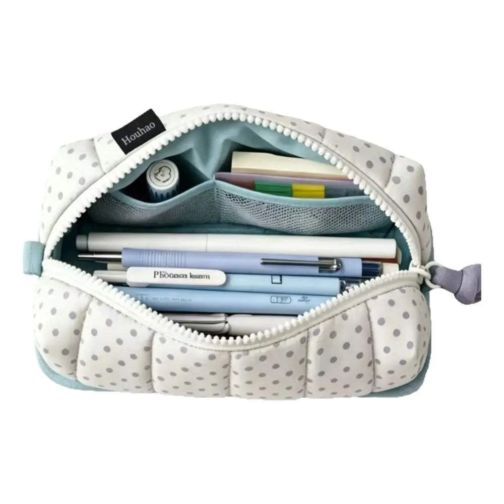 A light blue pencil case with a white dot pattern, featuring multiple compartments for pens and pencils.
