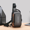 A dark brown men's Oxford sling chest bag with a padded phone pocket and black strap resting on a wooden surface.