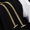 Gold chain strap for a handbag or crossbody bag displayed on black fabric.
