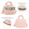 A pink quilted mommy bag with a strap, showing the interior and exterior details.