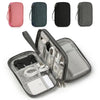 A set of four portable digital accessory organizer pouches in pink, dark blue, black, and gray.