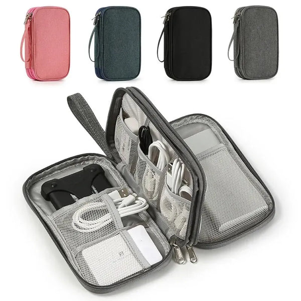 A set of four portable digital accessory organizer pouches in pink, dark blue, black, and gray.