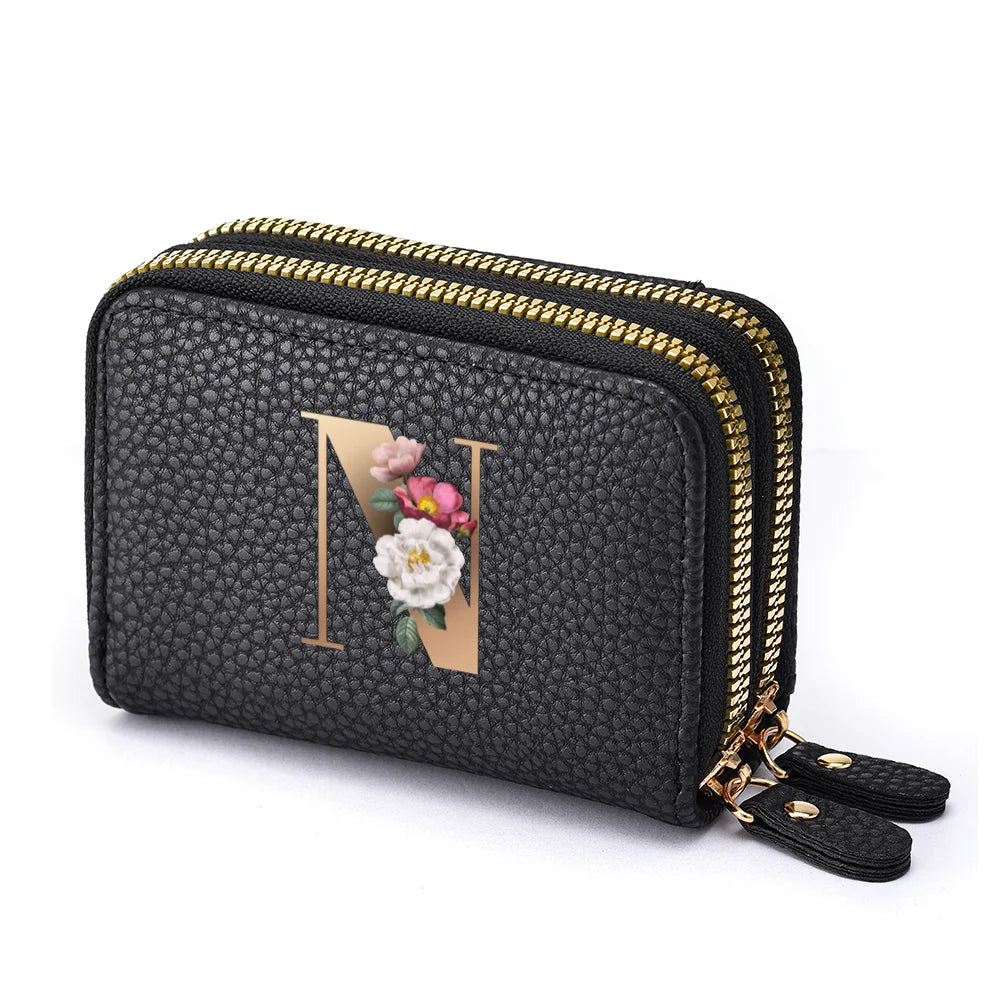Black mini wallet with a floral letter print and gold zipper details