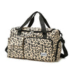 A leopard print travel duffel bag with a shoe compartment and black handles.