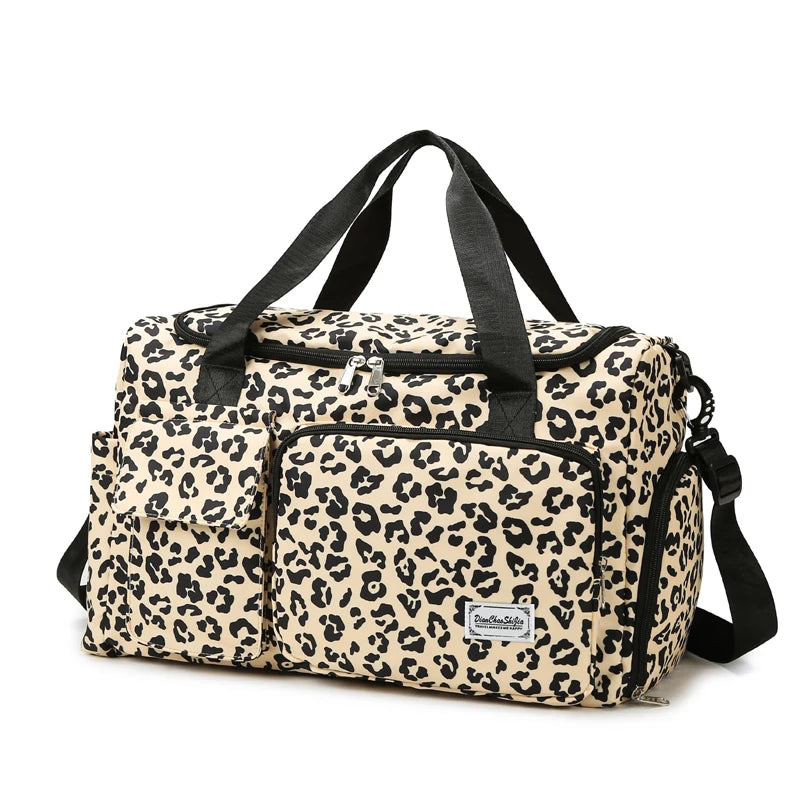 A leopard print travel duffel bag with a shoe compartment and black handles.