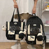 A black and cream Kawaii Harajuku backpack with a laptop compartment being held by a person.