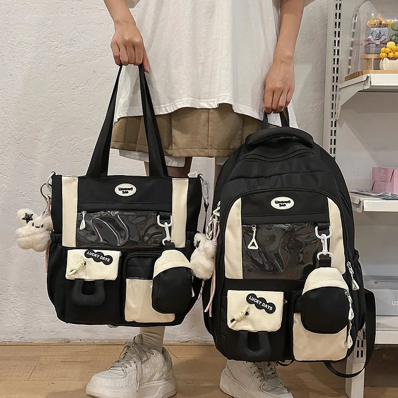 A black and cream Kawaii Harajuku backpack with a laptop compartment being held by a person.