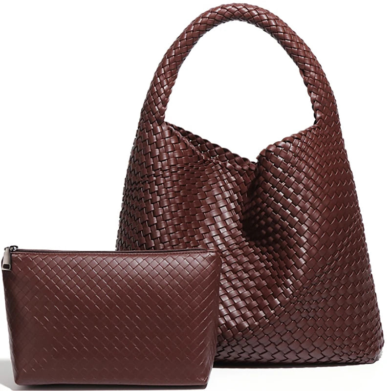 A brown handwoven faux leather tote bag and matching clutch displayed together.