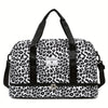 A black and white leopard print nylon travel duffle bag with black straps.