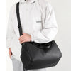 A person is holding a black multifunctional dry/wet separation travel backpack.