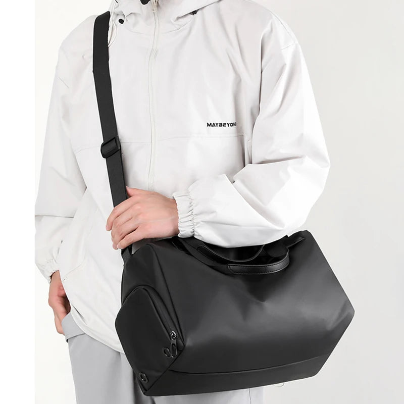 A person is holding a black multifunctional dry/wet separation travel backpack.