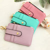 Three stacked silicone PU leather key chain wristlet wallets in pink, mint green, and lavender on a white background.