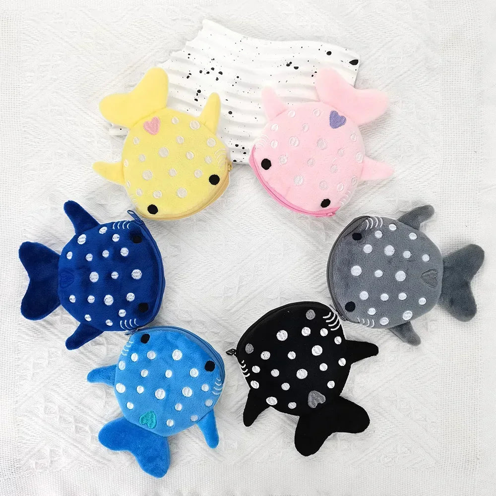 A collection of cute shark mini plush coin purses and wallets in various colors like yellow pink blue and gray